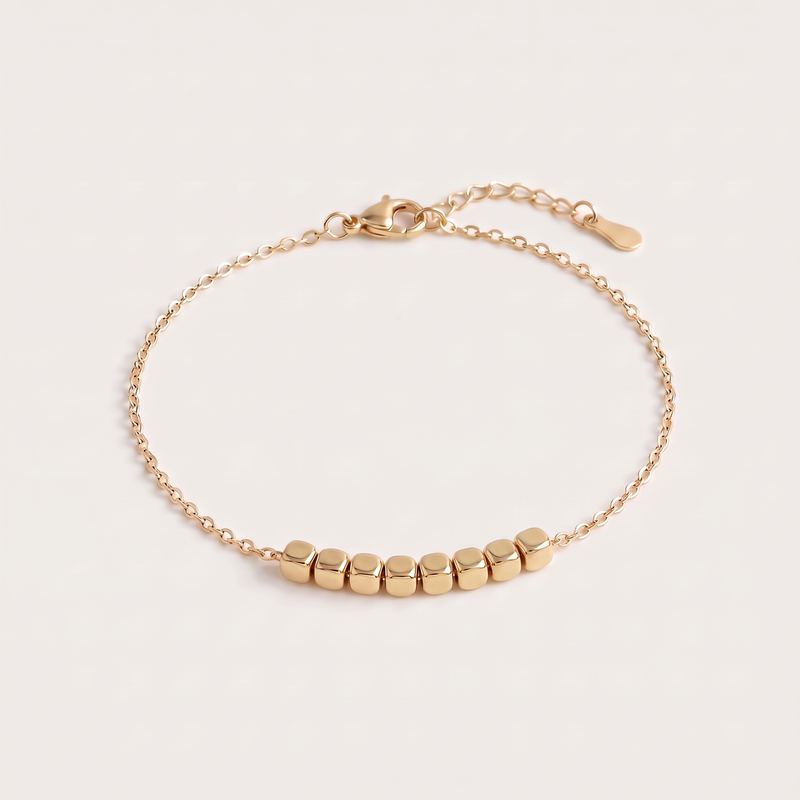 Block Bracelet in gold: eight square blocks on a fine O-link chain