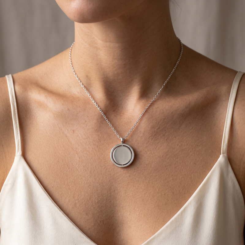 Spinner Necklace in silver, worn at the collarbone