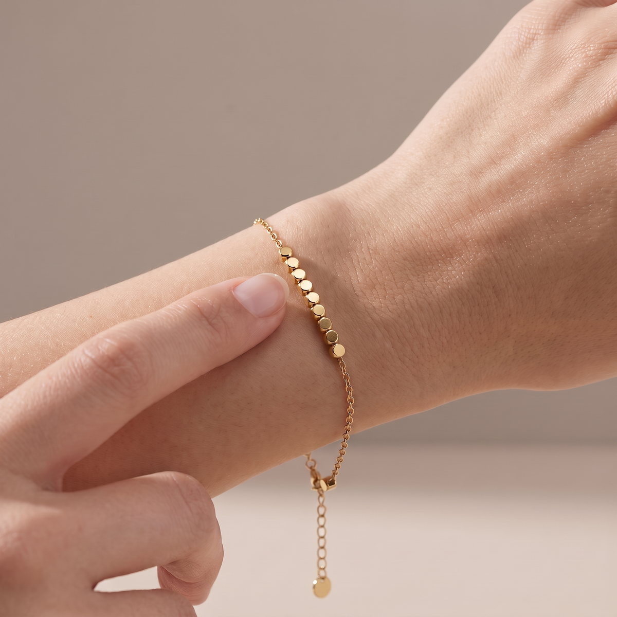 Block Bracelet in gold, worn on the wrist with a block under the thumb