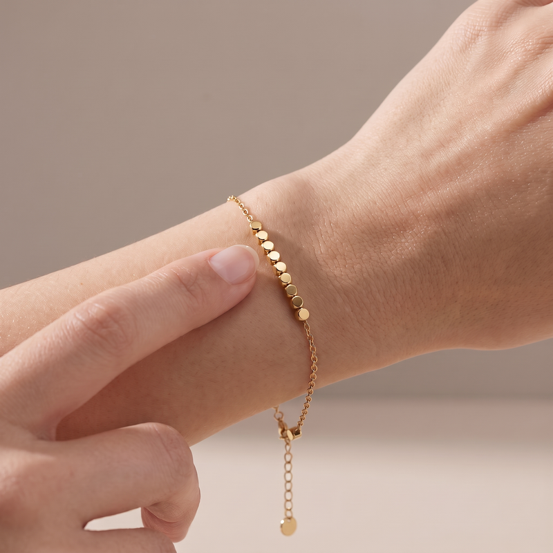 Block Bracelet in gold, worn on the wrist with a block under the thumb