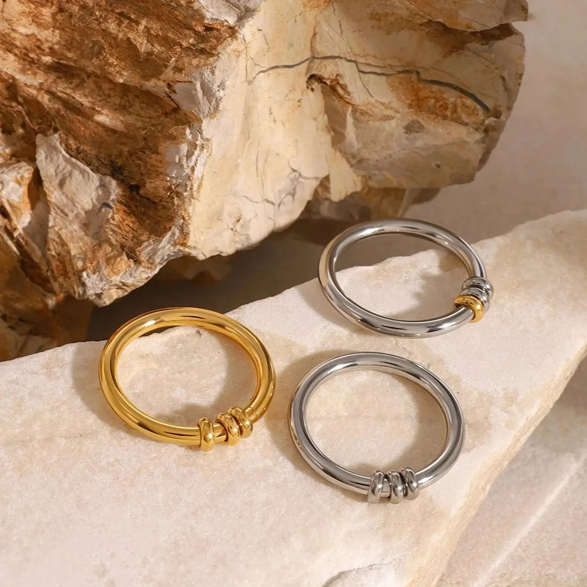 Arc Ring in gold and silver, styled on stone