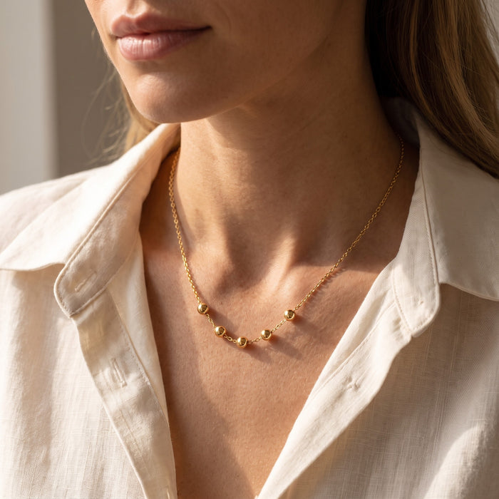 Slider Necklace in gold, worn at the collarbone