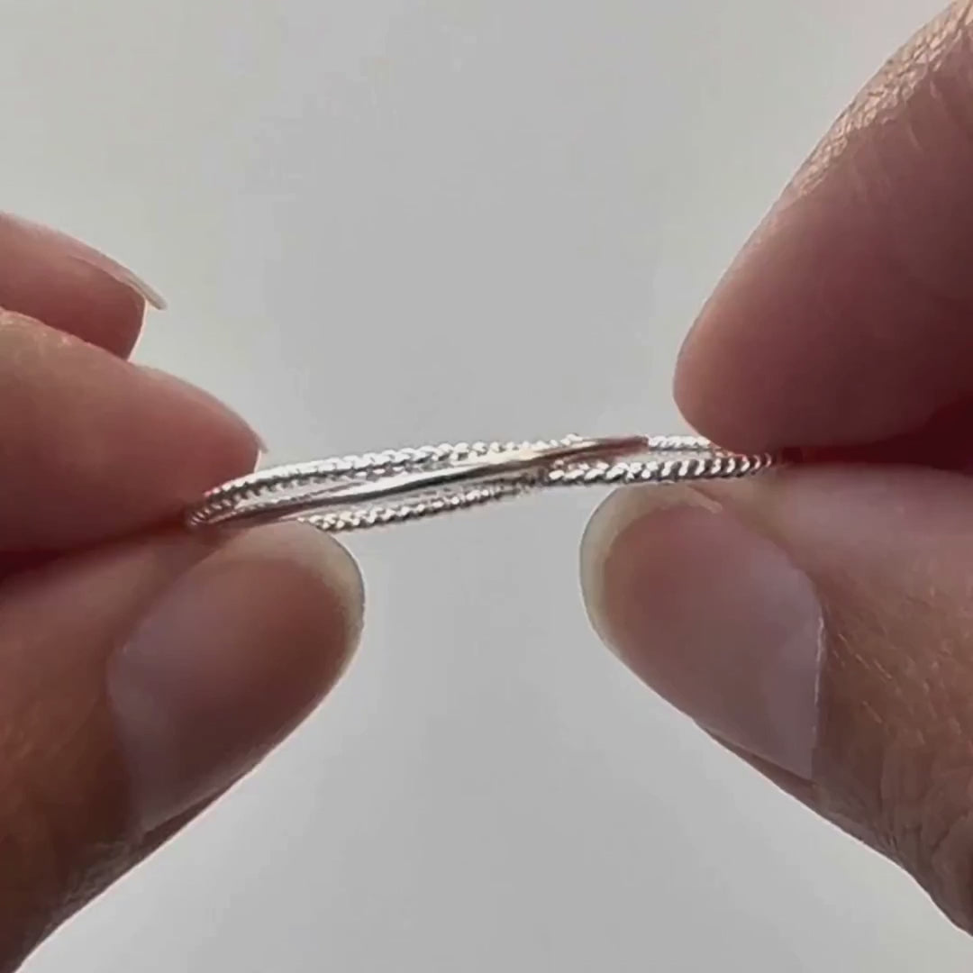 Rope Ring in silver, a thumb running along the twist