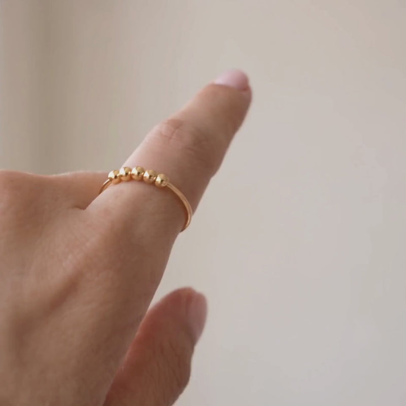 Slider Ring in silver, beads sliding under a fingertip
