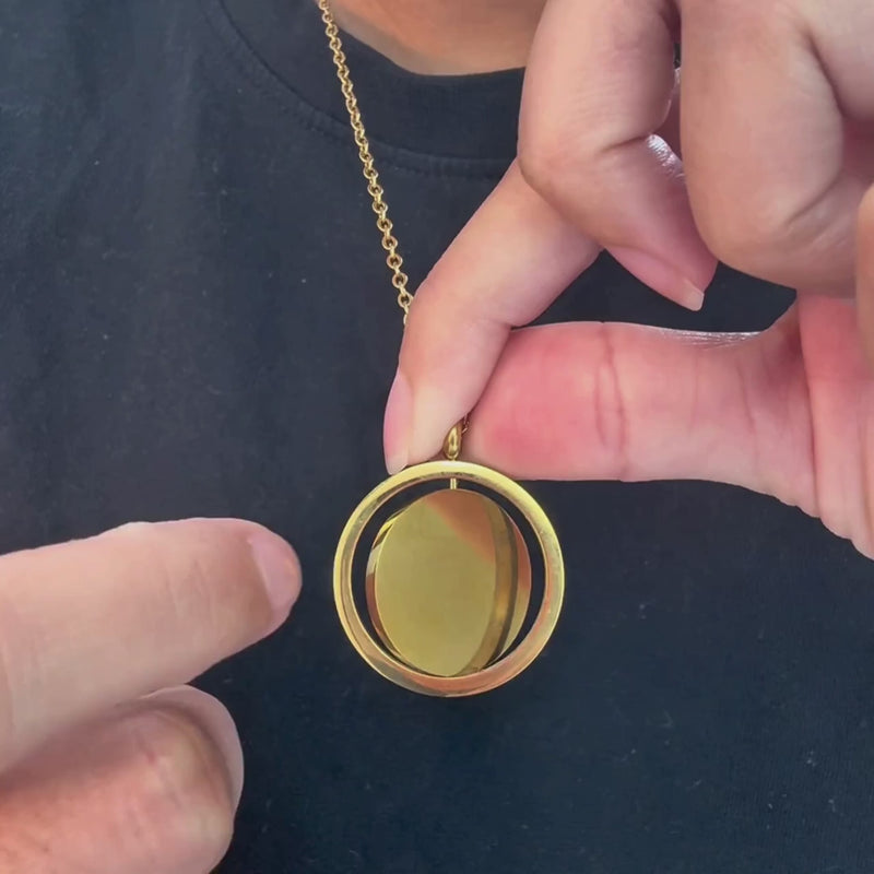 Spinner Necklace, the disc turning between two fingers